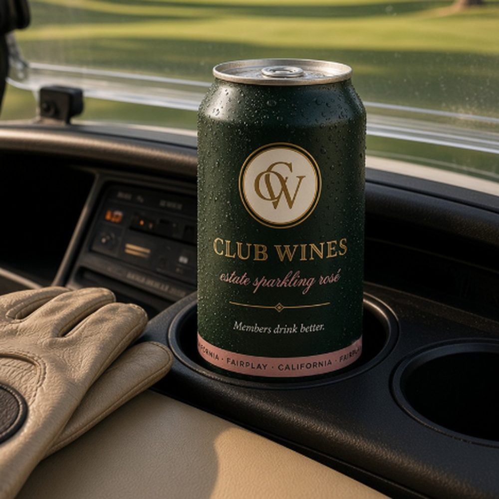 A Club Wines can in the cupholder of a golf cart looking out over the fairway